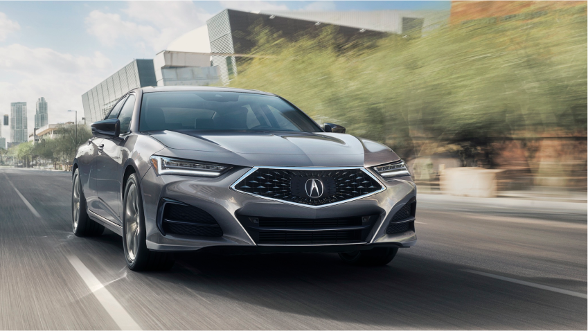 Front view on grey TLX on downtown street.