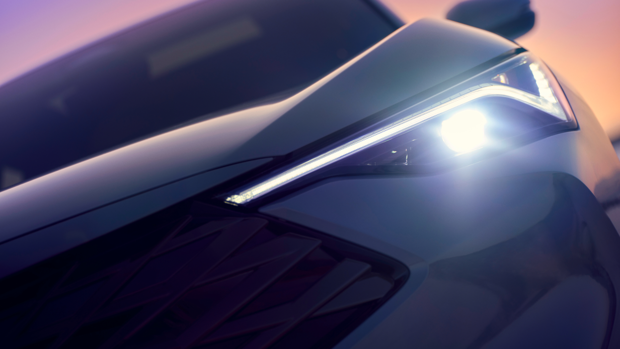 Stylized close-up of front headlight on an Acura ADX. 