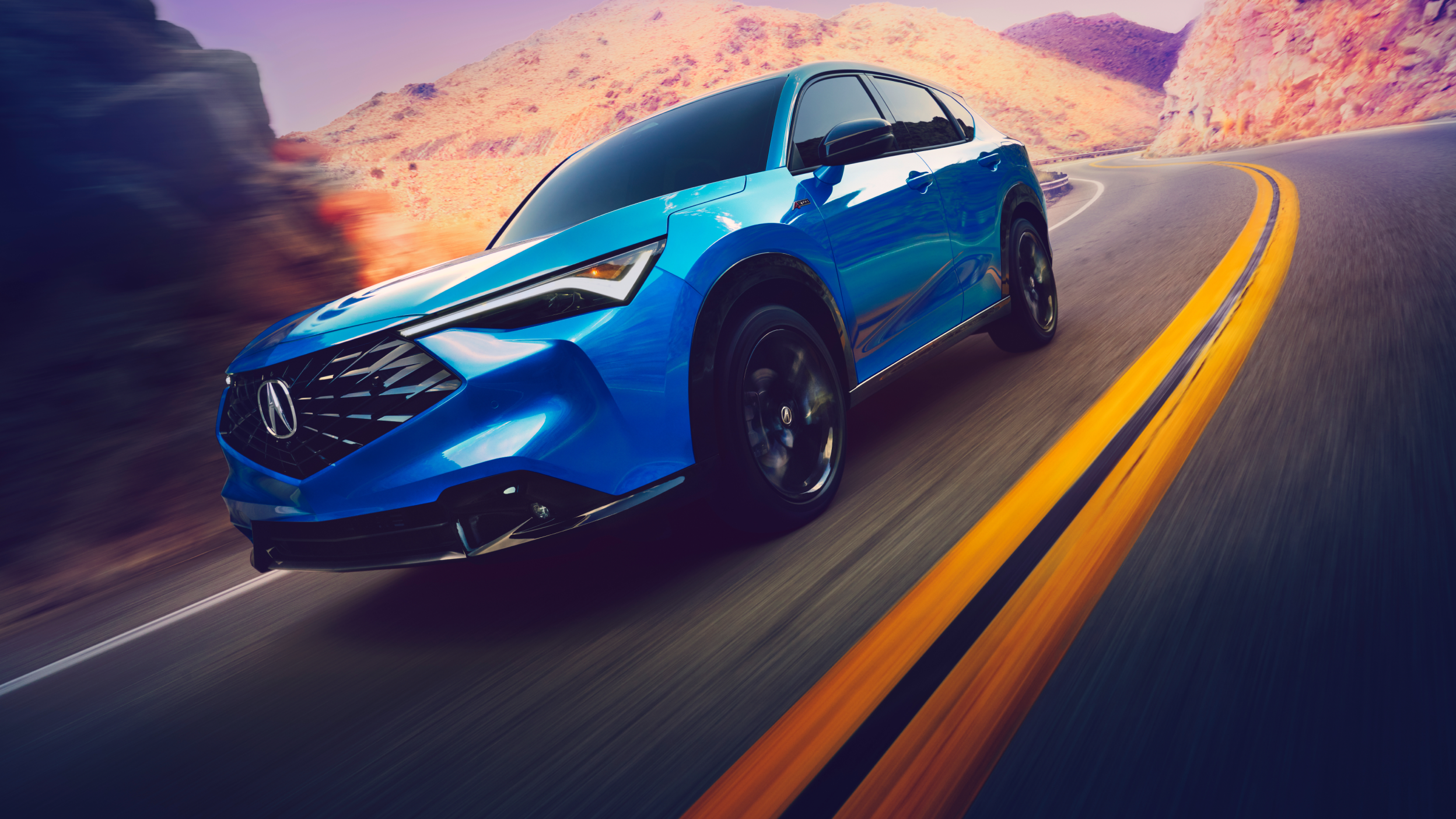 Side view of an Acura ADX turning the corner on a mountain highway. 